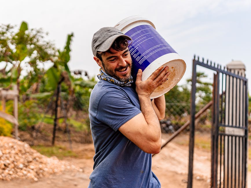 Professional worker carrying a large container at a work site